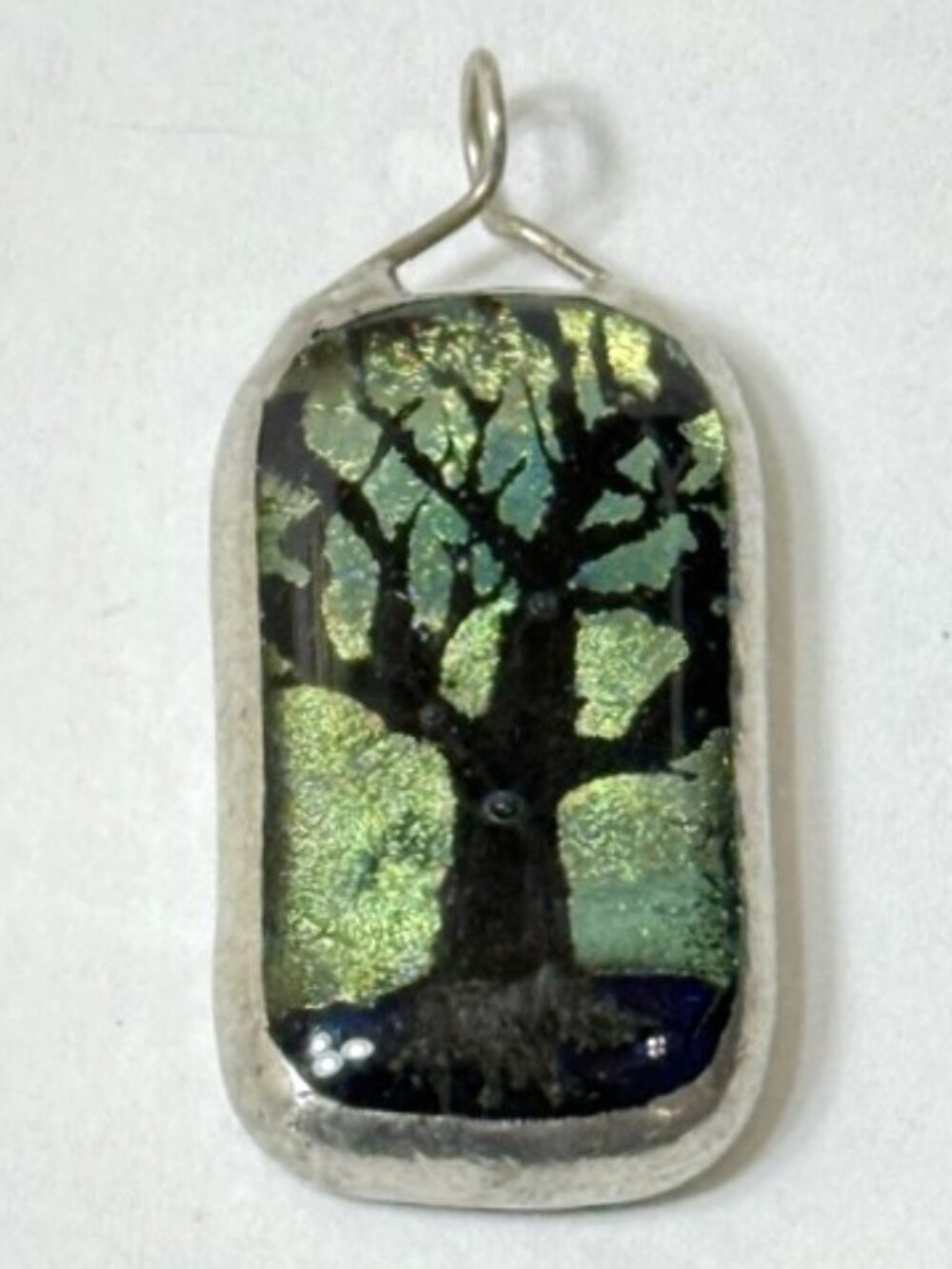 Dichroic glass rectangular green and black tree pendant.